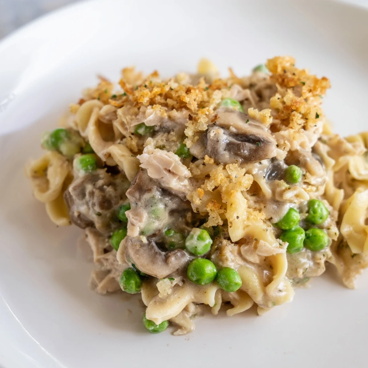 A warm, creamy Homemade Tuna Noodle Casserole bubbling in a baking dish, calling for a bite!