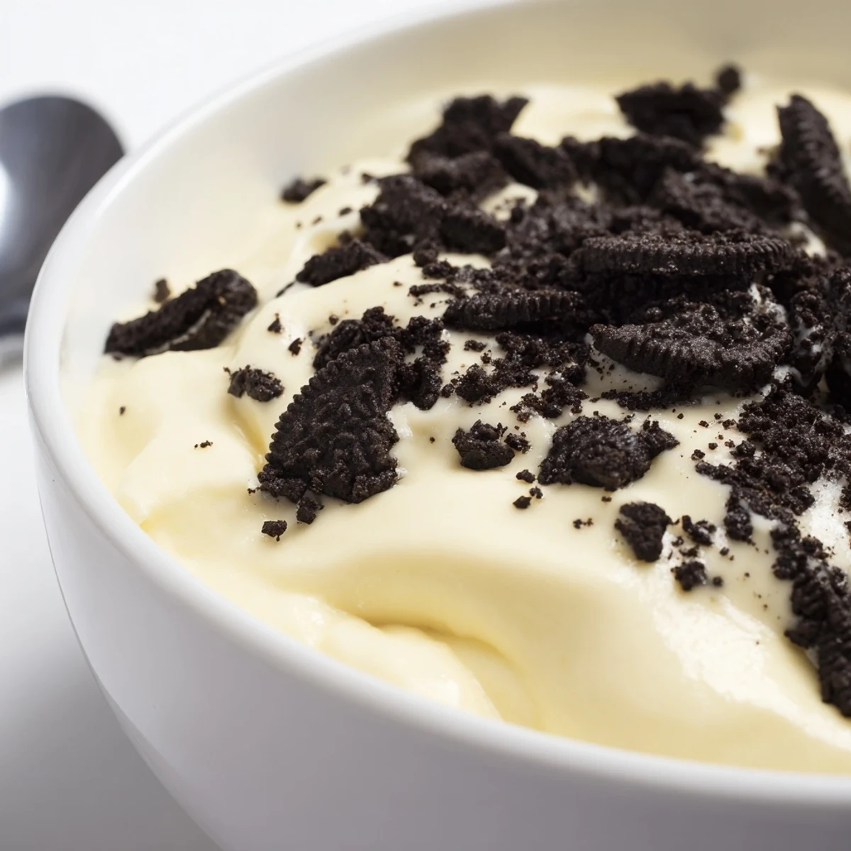 Creamy vanilla pudding with Oreo crumbs, a classic dessert perfect as a comforting treat.