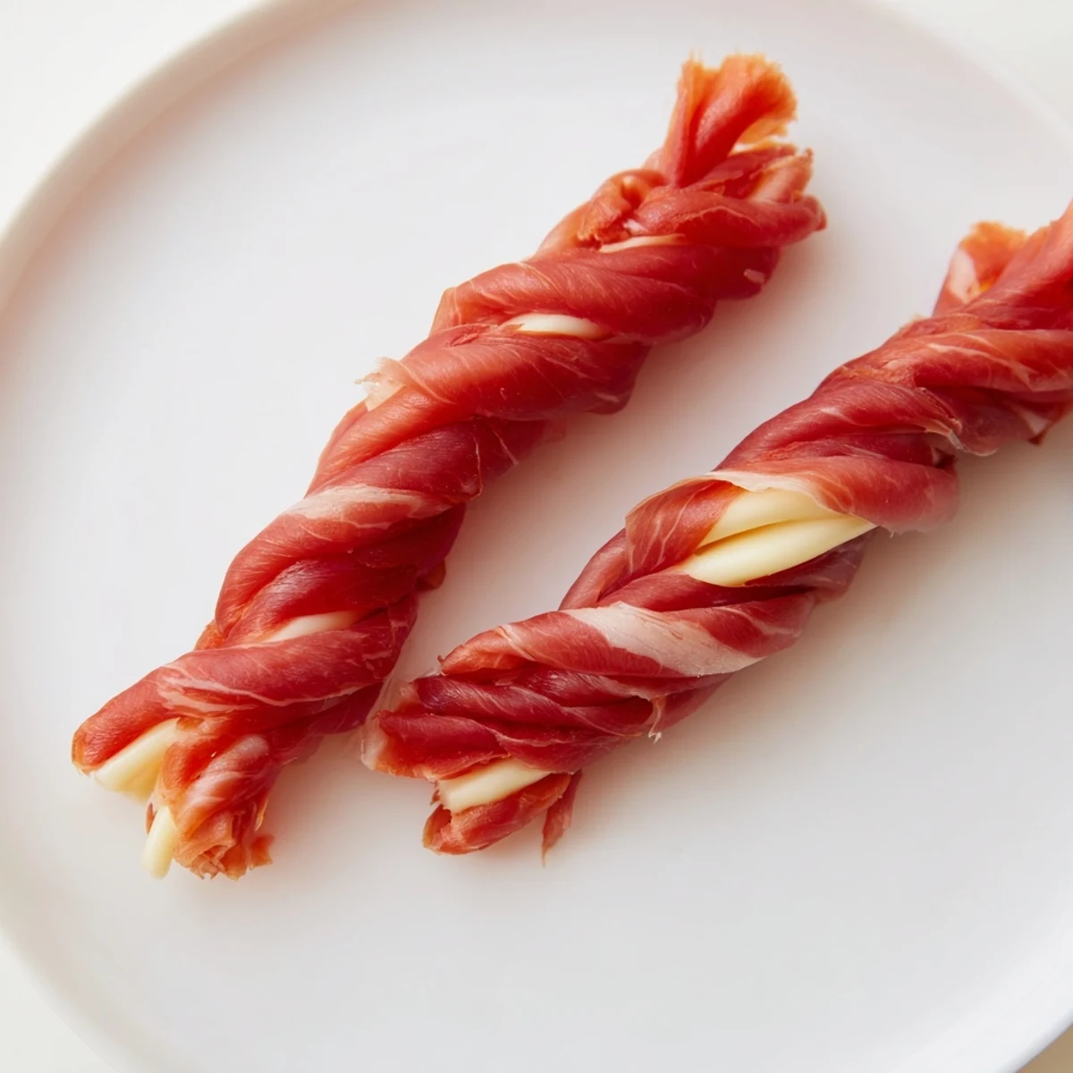 Nautical Knots appetizer: Braided prosciutto-wrapped cheese, a savory, gluten-free snack, ready to eat.