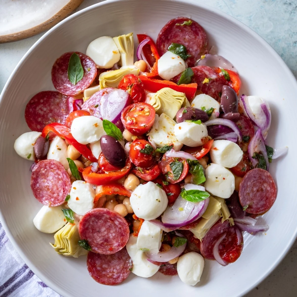 Vibrant Antipasto Chickpea Salad overflowing with colorful vegetables, chickpeas, and creamy mozzarella.