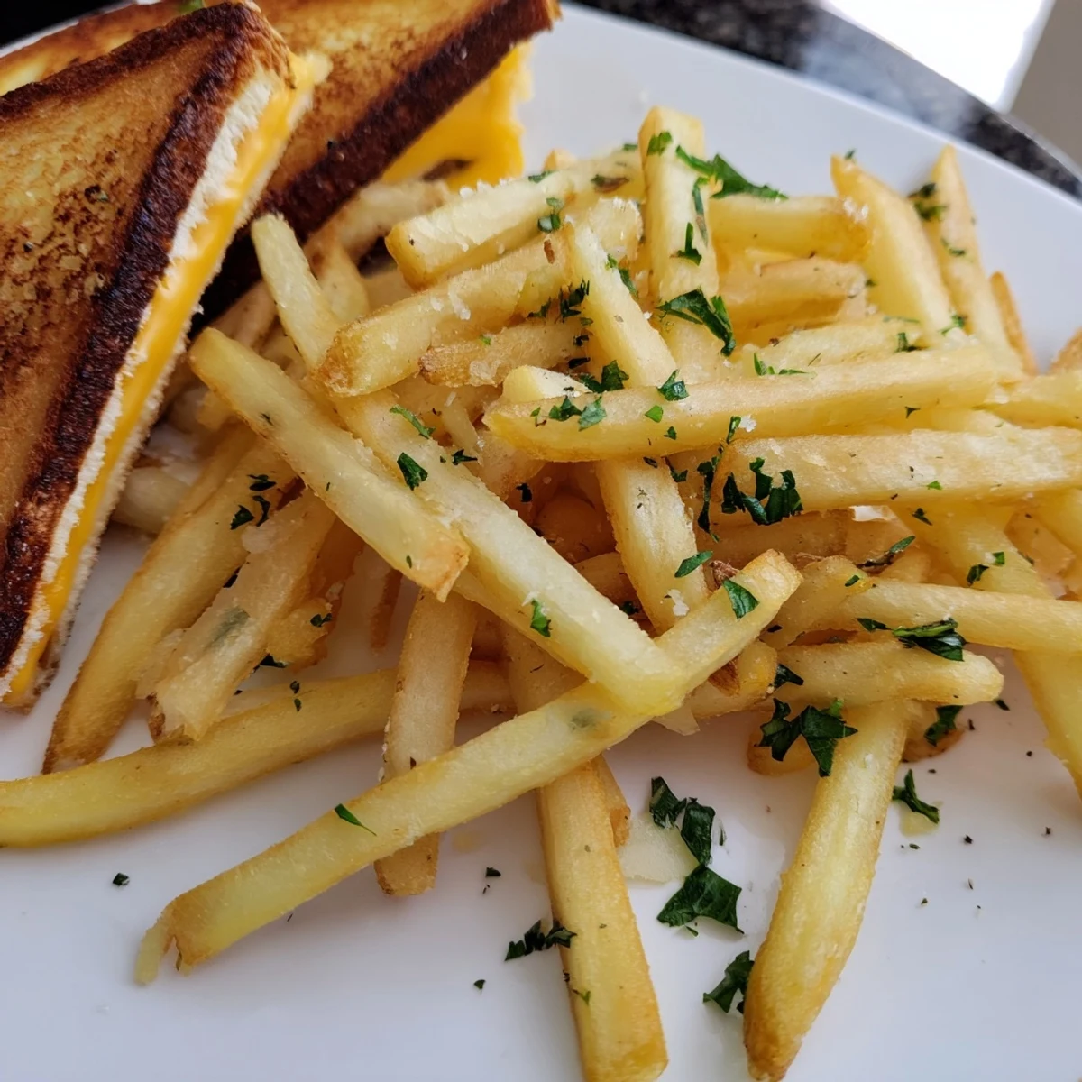Mouthwatering image of a grilled cheese sandwich and beef tallow French fries, golden and delicious.