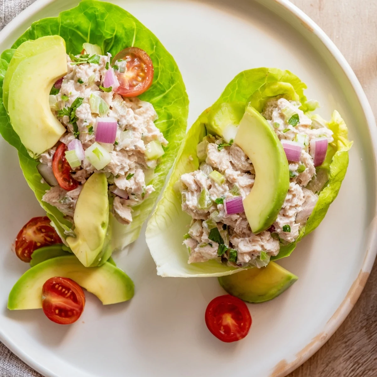 Brightly plated tuna salad lettuce wraps showcase a light, healthy lunch option for everyone.