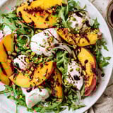 This Grilled Peach Salad features juicy peaches grilled to perfection with fresh arugula and burrata cheese.