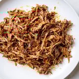 Moist and flavorful Omani Shuwa—the fall-apart lamb—is ready to be served with fluffy rice.