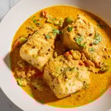 Steaming hot Bahraini Fish Curry, garnished with fresh cilantro, ready to be served over rice.