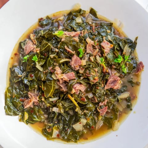 Steaming bowl of Rustic Southern Collard Greens with Smoked Turkey, ready for serving alongside cornbread.