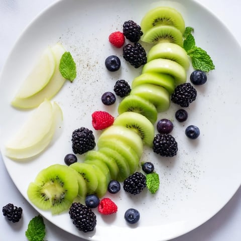 Vibrant The Aurora Borealis Sweep: a dazzling fruit platter of green and purple fruits, ideal for entertaining.