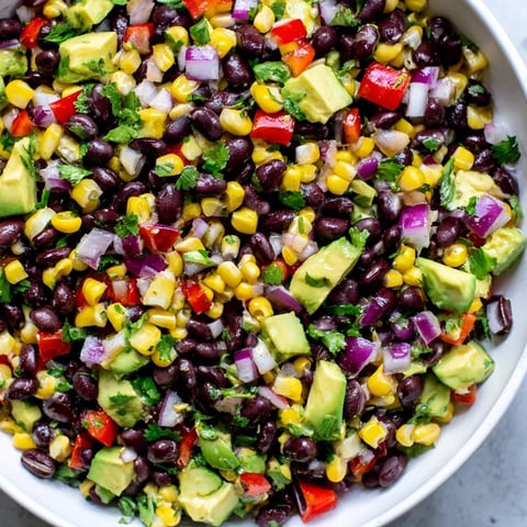 Close-up of vibrant Southwest Black Bean Salad, bursting with colorful, fresh ingredients in a bowl.