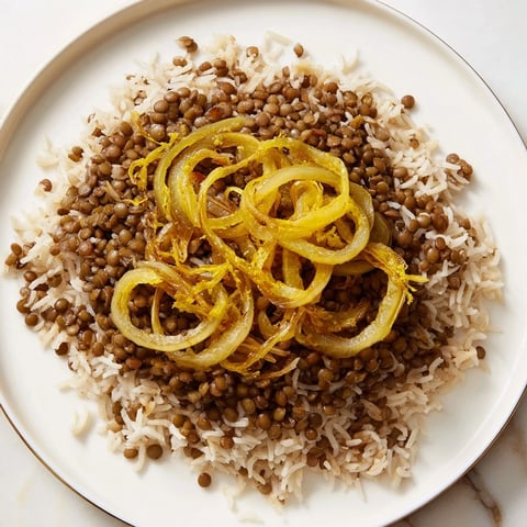 Golden caramelized onions topping a warm bowl of Lebanese Mjadra with perfectly cooked lentils and rice.