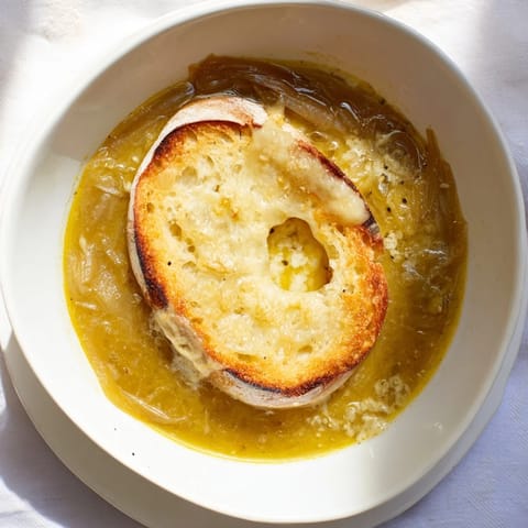 Aromatic, savory 4-Ingredient French Onion Soup: caramelized onions swimming in rich broth, ready to enjoy.