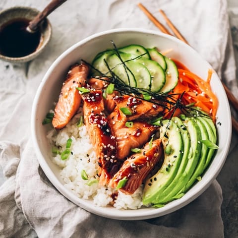 Vibrant Japanese-Style Salmon & Chicken Rice Bowl with flaked salmon, sliced chicken, and fresh veggies ready for serving.