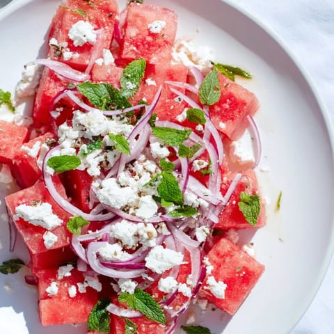 This colorful Watermelon Feta Salad features sweet watermelon, tangy feta, and a bright lime dressing, ready to eat!