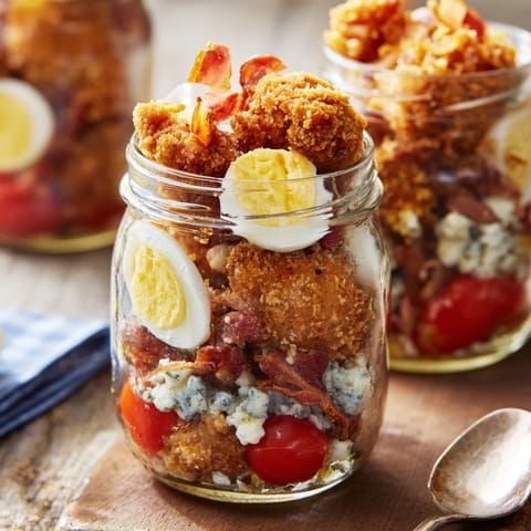 Shake up this Crispy Chicken Cobb Jar Salad for a delicious lunch with crispy chicken, blue cheese, and avocado layered over crisp romaine.