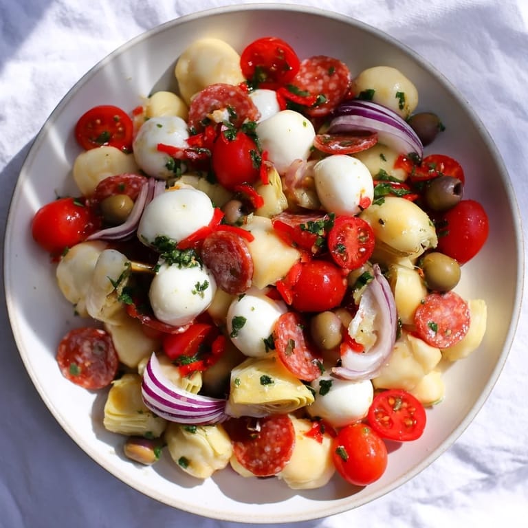 A refreshing bowl of zesty Antipasto Chickpea Salad with pepperoni, ready to eat now.