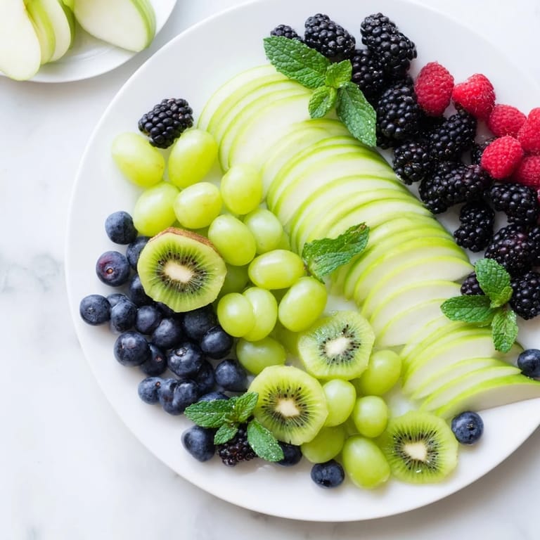 Stunning fruit arrangement: the Aurora Borealis Sweep, featuring waves of fresh grapes and kiwis, ready to enjoy.