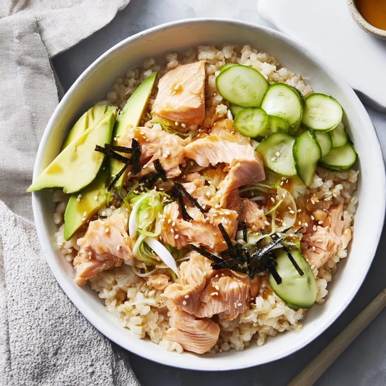 A delicious Japanese-Style Salmon & Chicken Rice Bowl featuring perfectly cooked rice, salmon, and a flavorful sauce.