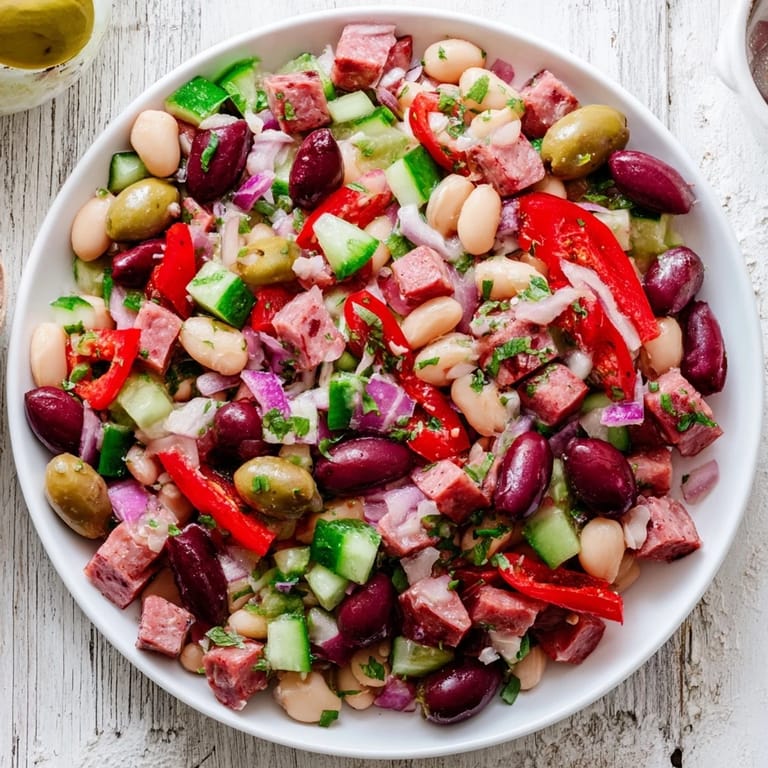 Bright, refreshing Mediterranean Dense Bean Salad with salami: a close-up showcasing fresh ingredients.