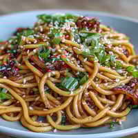 Aromatic Asian ginger scallion noodles tossed in a savory soy glaze with fresh scallions and chili.  