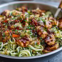 A colorful zucchini noodle stir fry with tender chicken and crisp vegetables in a savory Asian-inspired sauce.  
